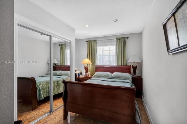 a living room with furniture kitchen view and a potted plant