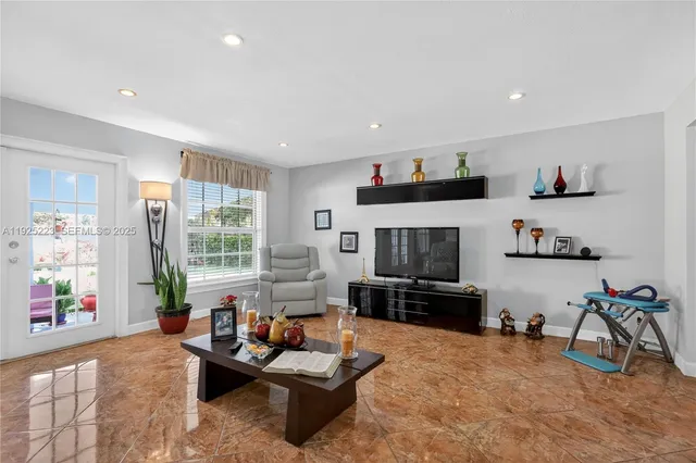 a kitchen with stainless steel appliances granite countertop a stove top oven a sink dishwasher and cabinets with wooden floor