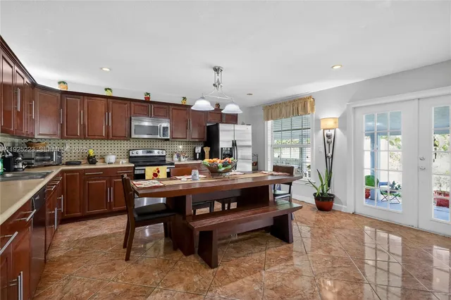 a living room with furniture a fireplace and a dining table with wooden floor