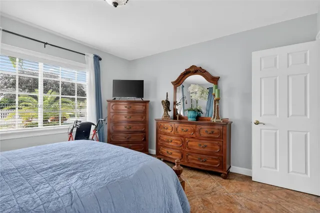 a dining room filled with furniture and potted plants