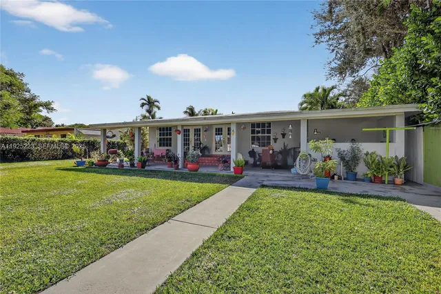 a bedroom with a bed a couch and a flat tv screen
