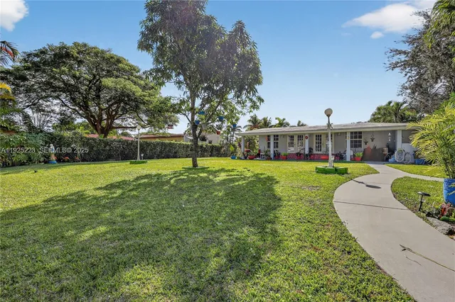 a kitchen with a refrigerator a stove top oven a sink and cabinets