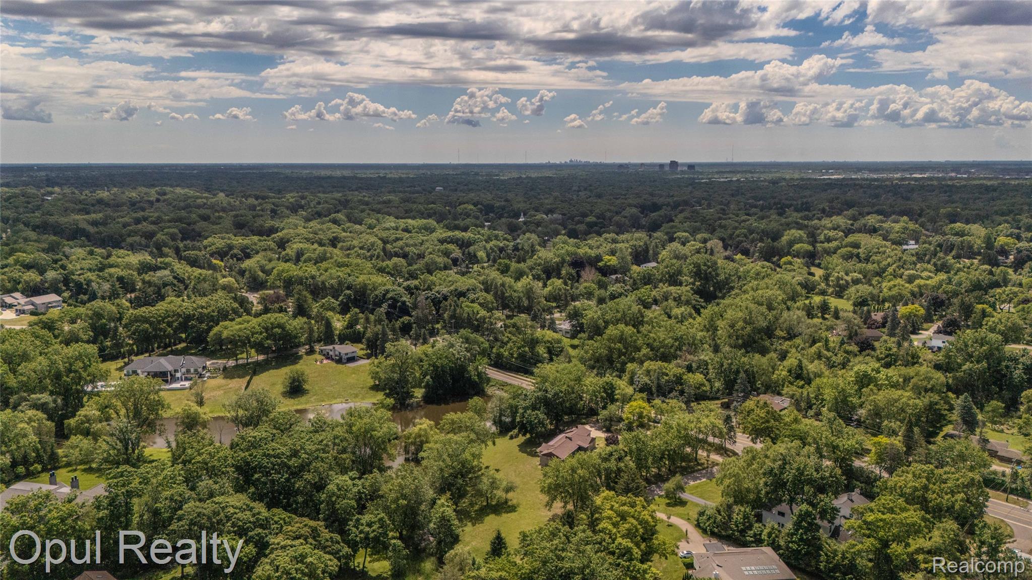 6455 Norham Road Bloomfield Hills, MI 48301 - Photo 72 of 93 Expansive aerial landscape highlighting a verdant treeline and residential properties