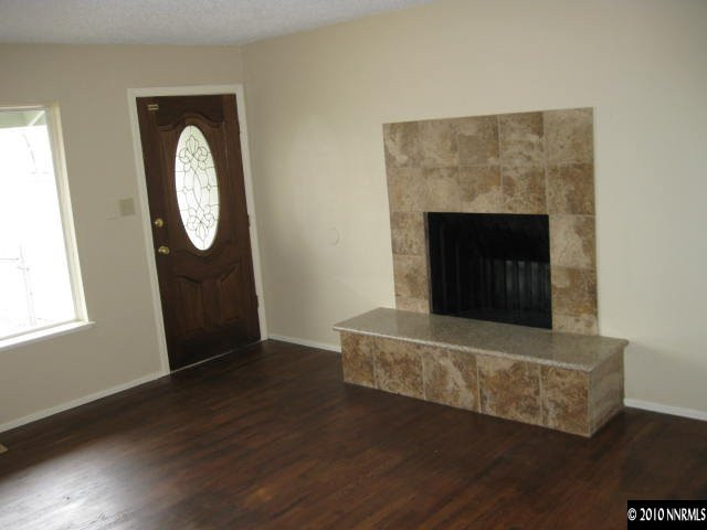 2285 East 9th Street Reno, NV 89512 - Photo 4 of 8 a view of a livingroom with wooden floor and a fireplace