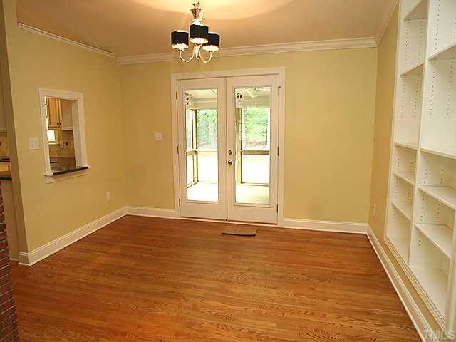 4300 Windsor Place Raleigh, NC 27609 - Photo 3 of 8 Beautiful dining room with built in bookcases and double french doors out to the screened in porch.