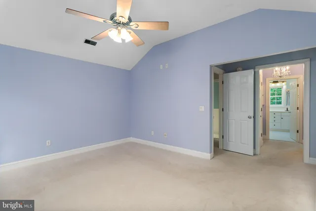 a view of a livingroom with wooden floor and a ceiling fan