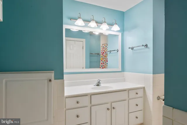 an aerial view of residential house with outdoor space and trees all around