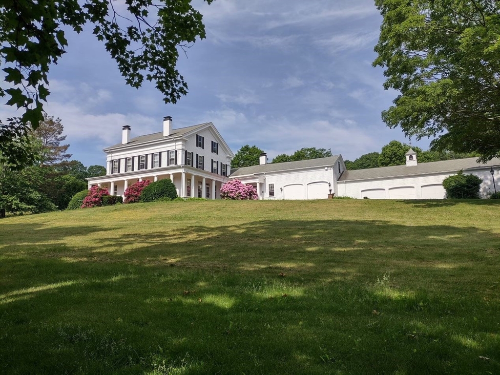 a view of a house with a big yard and garden