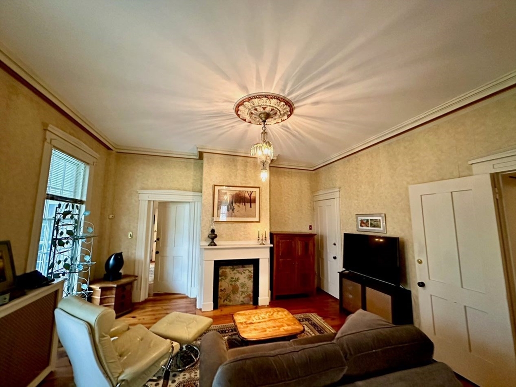 1341 Hardwick Road Hardwick, MA 01037 - Photo 16 of 27 a living room with furniture a fireplace and a chandelier