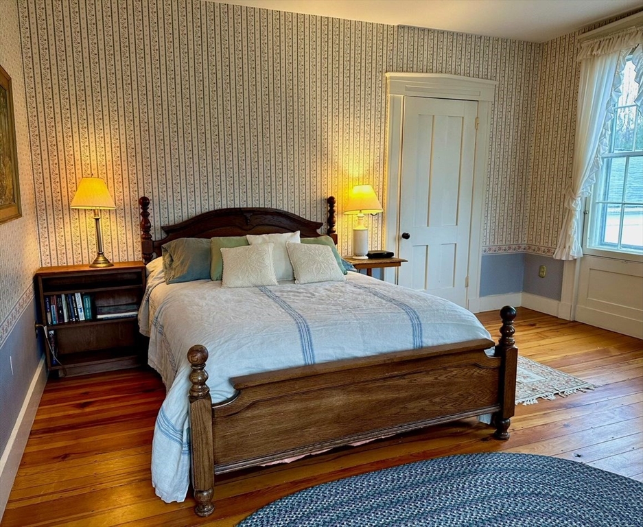 1341 Hardwick Road Hardwick, MA 01037 - Photo 24 of 27 a bedroom with a bed and wooden floor
