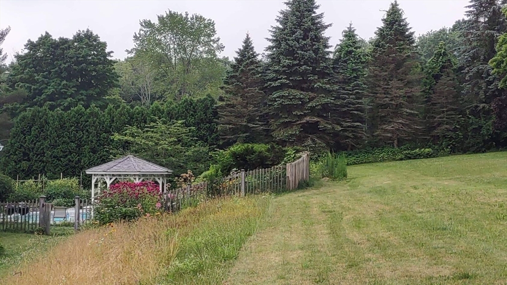 1341 Hardwick Road Hardwick, MA 01037 - Photo 5 of 27 a backyard of a house with lots of green space and lake view