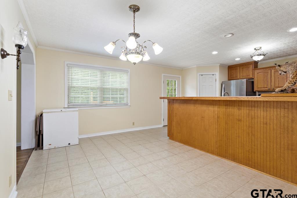 448 North Hill Road Tyler, TX 75706 - Photo 4 of 30 a view of a livingroom with a chandelier furniture and windows