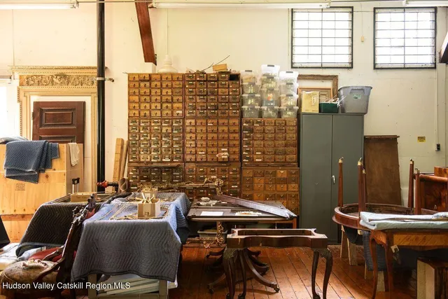 a view of a workspace with furniture and a window
