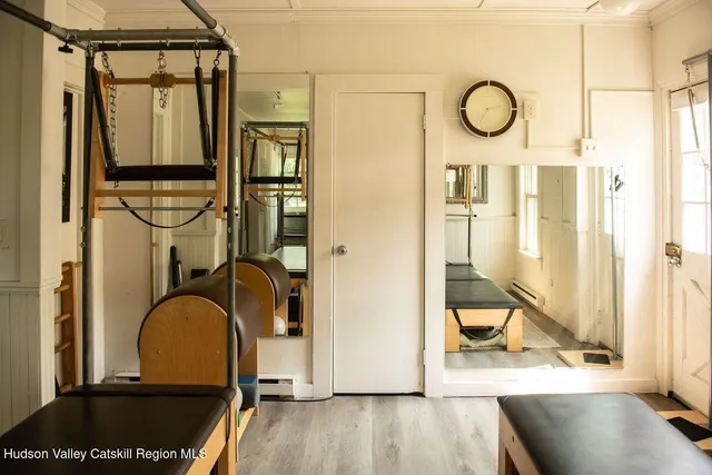 a view of a room with wooden floor and furniture