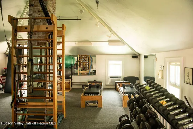 a view of a living room with a couch and wooden floor