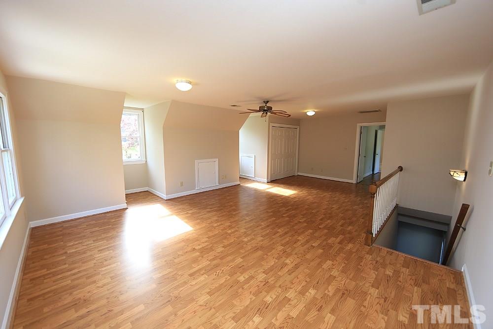 7809 Ketley Court Raleigh, NC 27615 - Photo 25 of 30 Large Bonus Room with its own staircase down to the back of home in hall leading to garage. Two wonderful spots for window seats here and great shelves in closets.