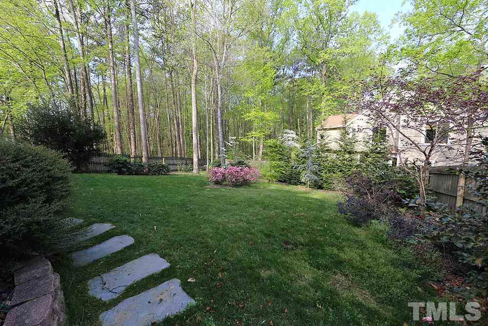 7809 Ketley Court Raleigh, NC 27615 - Photo 27 of 30 Side entrance to fenced in back yard with lovely bushes and flowers.
