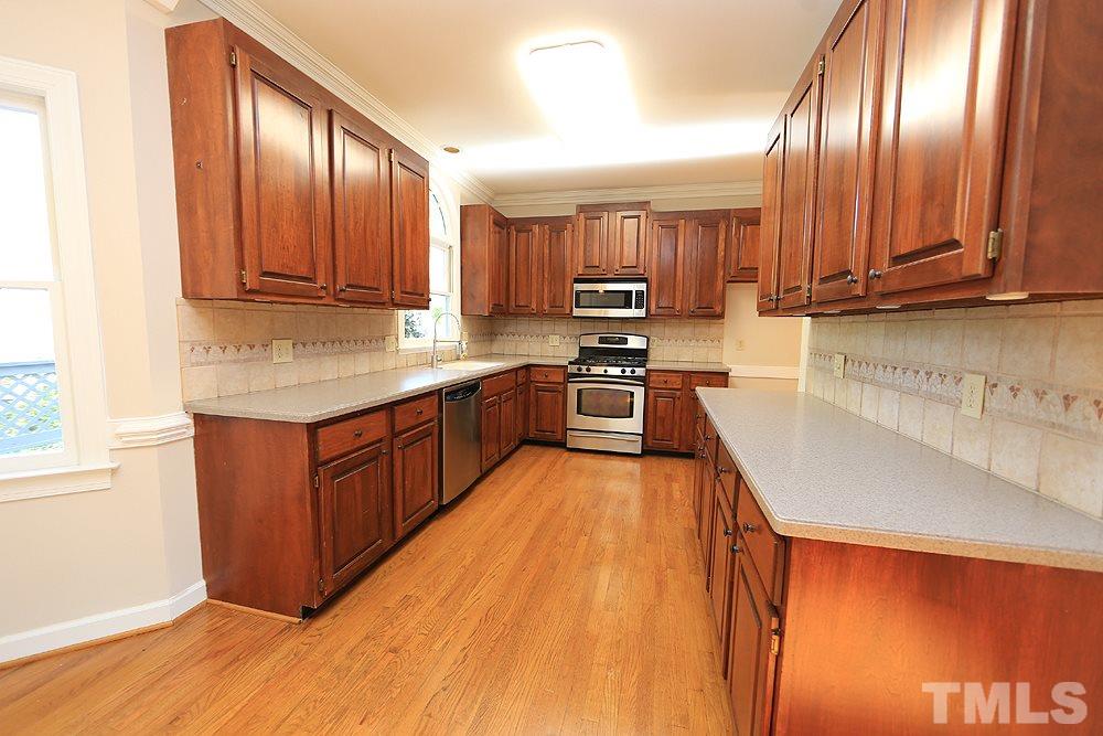 7809 Ketley Court Raleigh, NC 27615 - Photo 8 of 30 Plenty of room to cook in this Kitchen while enjoying the beautiful view out back.