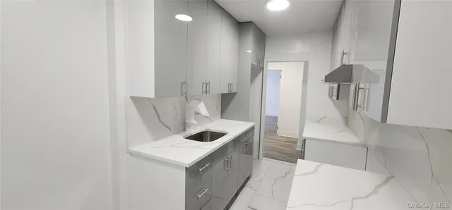 a kitchen with a sink and refrigerator