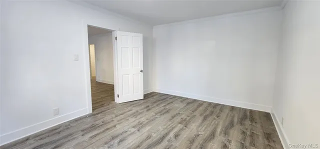 an empty room with wooden floor