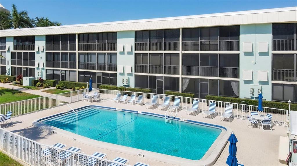 9200 Midnight Pass Road, Unit 24 Sarasota, FL 34242 - Photo 39 of 43 a view of a house with a swimming pool and sitting area