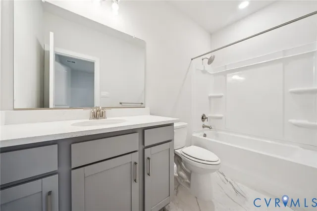 a bathroom with a sink a toilet and a large mirror