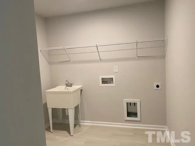 a bathroom with a sink a chair and a table