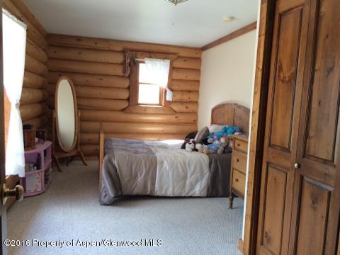 1977 County Road 210 Rifle, CO 81650 - Photo 11 of 16 a bedroom with bed and a window