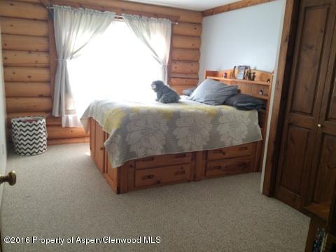 1977 County Road 210 Rifle, CO 81650 - Photo 12 of 16 a bed sitting in a bedroom next to a window