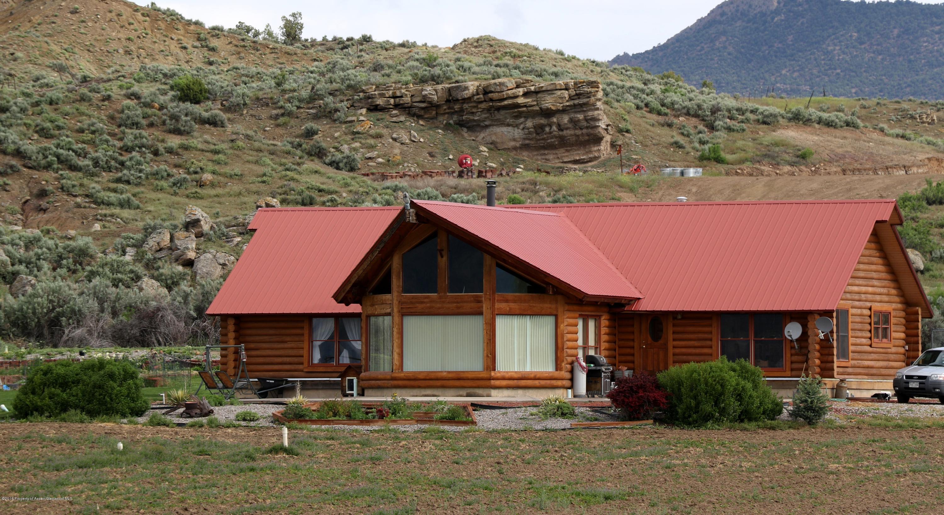 1977 County Road 210 Rifle, CO 81650 - Photo 2 of 16 a front view of a house with garden