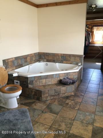 1977 County Road 210 Rifle, CO 81650 - Photo 9 of 16 a bathroom with a bathtub and a toilet