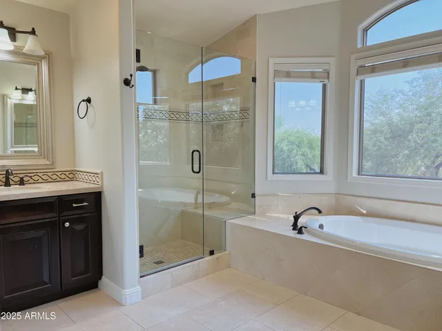 a bathroom with a tub sink and shower