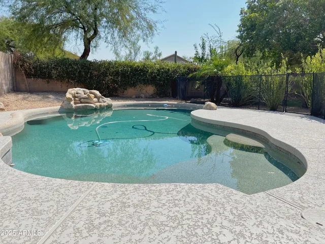 a view of a swimming pool with a yard