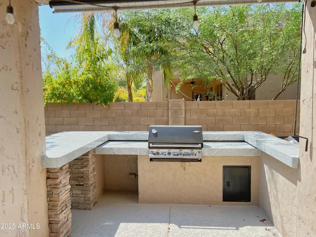 a kitchen with a stove and a white house