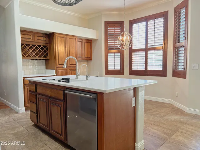 a sink with a large mirror next to a window