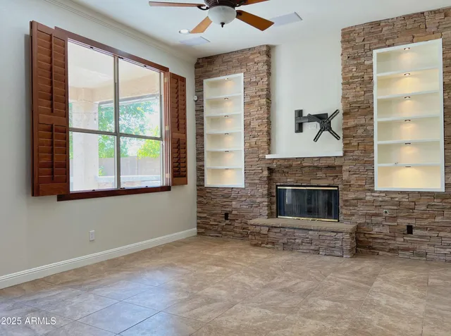 a living room with furniture a fireplace and a large window