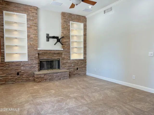 a view of empty room with a fireplace and window