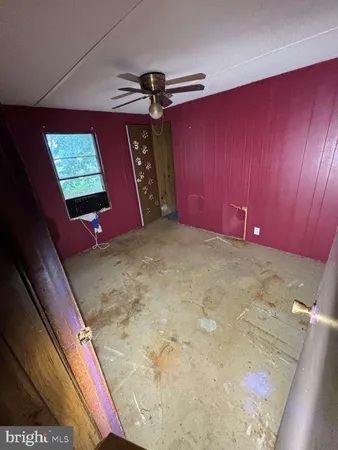 a view of a room with wooden floor and windows