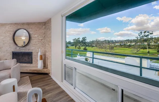 a view of a room with wooden floor and outdoor view