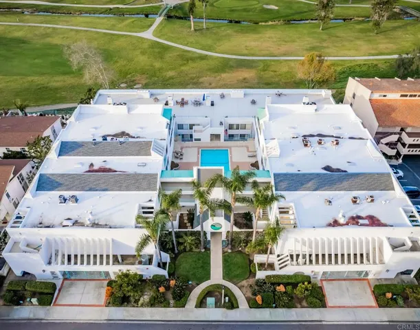 a view of a house with pool and chairs