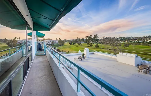 a view of a balcony with chairs and table