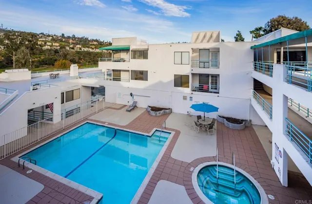 a front view of a house with swimming pool having outdoor seating