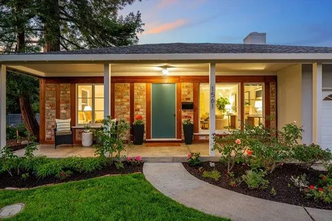 a front view of house with a garden
