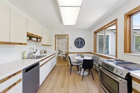 a kitchen with a stove a sink and a refrigerator