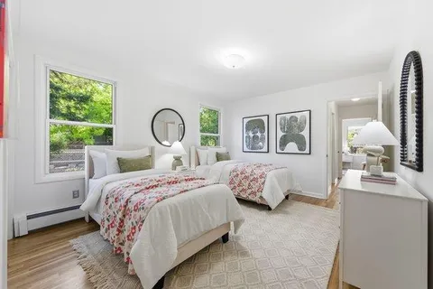 a bedroom with bed and a large window