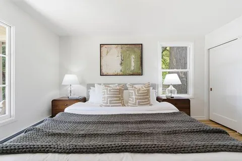 a bedroom with a bed and a window