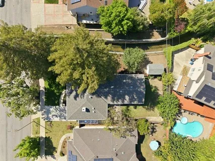 an aerial view of a house with a yard