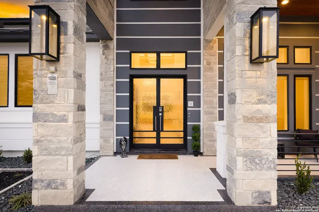 a view of a dining room with furniture a chandelier and wooden floor