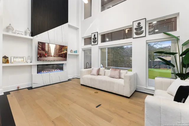 a spacious bedroom with a large bed and a chandelier