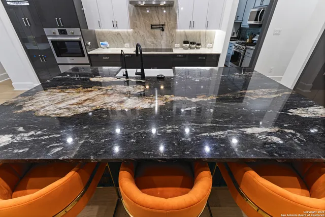 a spacious bedroom with a bed and a flat screen tv